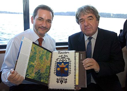 Kurator Arnold Aescht (rechts) berreicht Ministerprsident Matthias Platzeck einen Burzenland-Bildband und ein gesticktes Zeidner Wappen. Foto: Bernd Gartenschlger (Mrkische Allgemeine Zeitung)